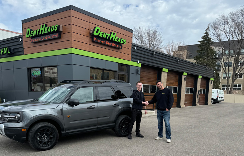 Handshake in Front of Bronco